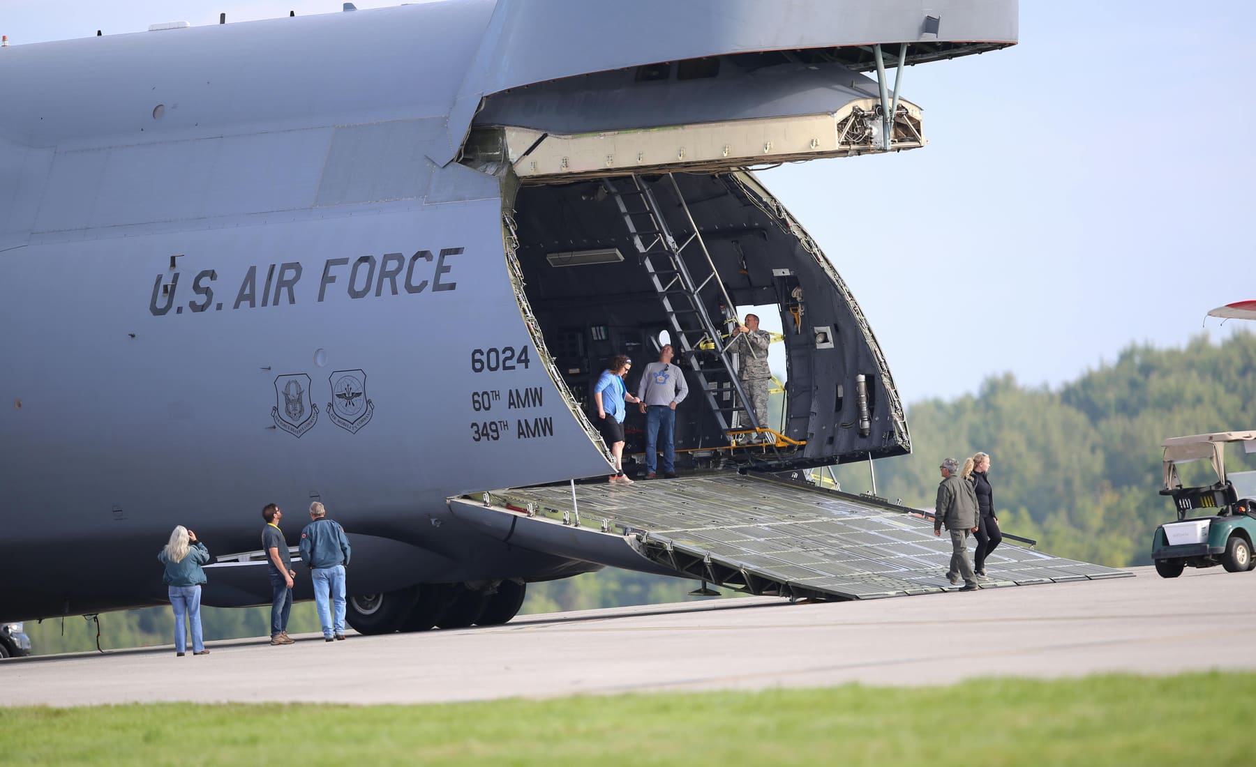 Military cargo aircraft loading on a flightline at dusk